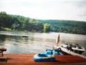Lakehouse Vacation Rental - Lake Homes for rent on LakeHouseVacations.com, Lake property, Lake House Lake House Lakefront Cottage For Summer Rental, View from deck with dock & motorboat, on Lake Owassa in New Jersey - Lakehouse Vacation Rental - Lake Home for rent on LakeHouseVacations.com
