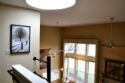 Lakehouse Vacation Rental - Lake Homes for rent on LakeHouseVacations.com, Lake property, Lake House Lake House Level Beach, Dock, 4 Bed 2 1/2 Bath Oasis, View from the second level down to the Dining Room, sky light up above, on East Side Cayuga Lake in New York - Lakehouse Vacation Rental - Lake Home for rent on LakeHouseVacations.com
