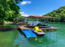 Lake House Lakeside Lodge 6 Bdrm/3.5 Bath W/ Hot Tub And Watercraft Rentals, Covered dock w/ 2 jet ski ports, swim platform, ladder, & picnic table, on Norris Lake in Tennessee - Lakehouse Vacation Rental - Lake Home for rent on LakeHouseVacations.com