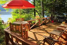 Lake House Secluded Lakeside Split-log Cottage With Fireplace, Rowboat, Bistro table and deck looking South, on Lake Horace in New Hampshire - Lakehouse Vacation Rental - Lake Home for rent on LakeHouseVacations.com