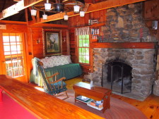 Lake House Secluded, Lakeside, Split-log Cottage With Fireplace, Rowboat, Fireplace and greatroom viewed from kitchen., on Lake Horace in New Hampshire - Lakehouse Vacation Rental - Lake Home for rent on LakeHouseVacations.com