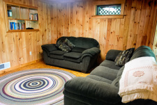 Lakehouse Vacation Rental - Lake Homes for rent on LakeHouseVacations.com, Lake property, Lake House Lake House Log House Maine Lake Shore Boats Fishing Swim Spa, Family room seating - patio and lawn outside sliding doors., on Sand Pond in Maine - Lakehouse Vacation Rental - Lake Home for rent on LakeHouseVacations.com