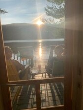 Lake House Lakeside Cottage For Rent On Lake Armington *closed For 2022 Season*, watching the sunset from the deck, on Lake Armington in New Hampshire - Lakehouse Vacation Rental - Lake Home for rent on LakeHouseVacations.com