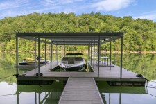 Lake House 6 Bd Lakefront Flat Hollow Cabin With Dock + Hot Tub, Covered slip, jet ski ports, picnic table and trex decking at the dock, on Norris Lake in Tennessee - Lakehouse Vacation Rental - Lake Home for rent on LakeHouseVacations.com