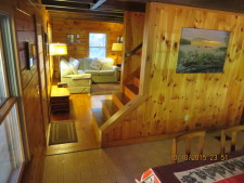Lakehouse Vacation Rental - Lake Homes for rent on LakeHouseVacations.com, Lake property, Lake House Lake House Log House Maine Lake Shore Boats Fishing Swim Spa, From dining area to living room, with stairs to upper level, on Sand Pond in Maine - Lakehouse Vacation Rental - Lake Home for rent on LakeHouseVacations.com